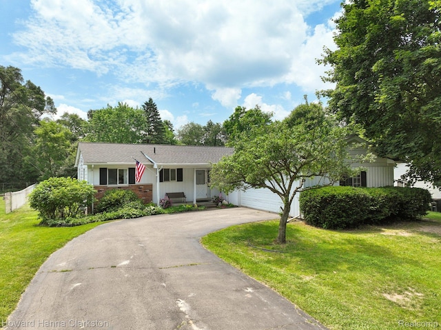 4220 England Beach Rd, White Lake, MI 48383 - single story home with asphalt driveway, a front lawn, covered porch, and a garage