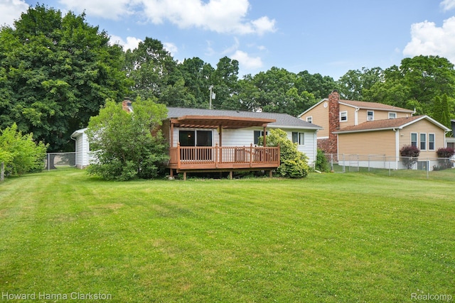 4220 England Beach Rd, White Lake, MI 48383 - rear view of house featuring a deck, a fenced backyard, and view of wooded area