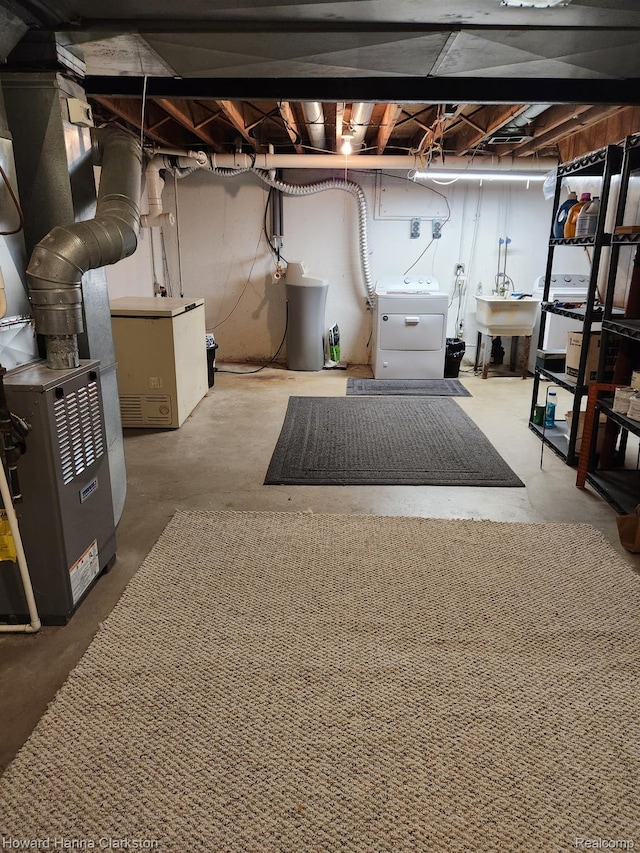 4220 England Beach Rd, White Lake, MI 48383 - unfinished basement featuring washer and dryer, heating unit, and a water softener