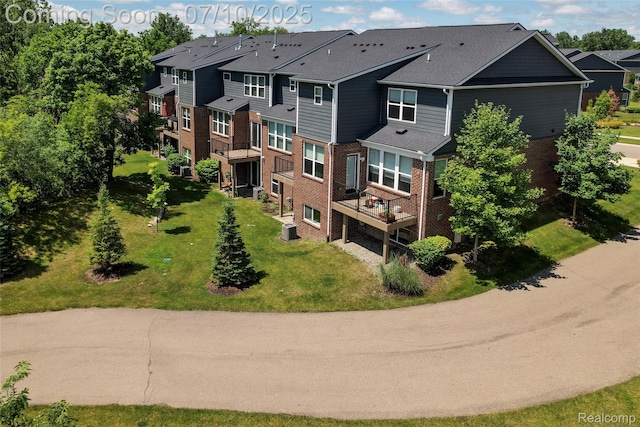 43433 Chancellor Ln, Novi, MI 48375 - rear view of property with brick siding and a lawn