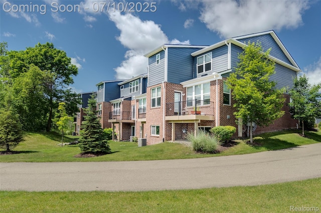 43433 Chancellor Ln, Novi, MI 48375 - rear view of house with brick siding and a lawn