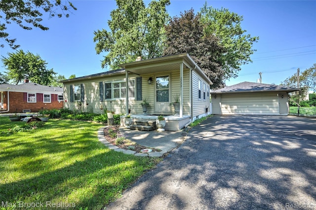 2233 Kohler St, Waterford, MI 48329 - view of front facade with a garage, a front lawn, and an outbuilding