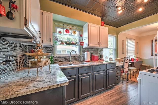 2233 Kohler St, Waterford, MI 48329 - kitchen with an ornate ceiling, light wood-style flooring, white range, tasteful backsplash, and white cabinets