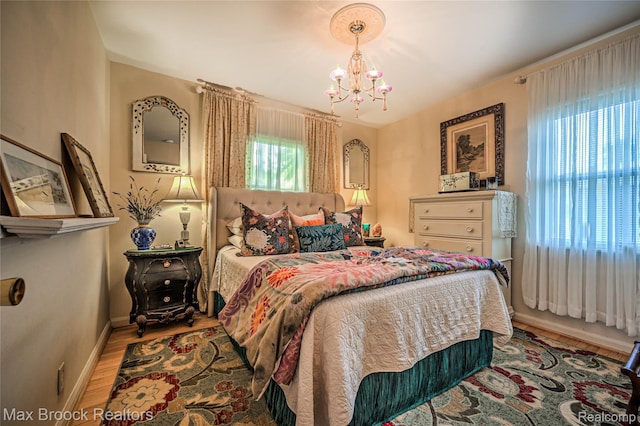 2233 Kohler St, Waterford, MI 48329 - bedroom with a chandelier and wood finished floors