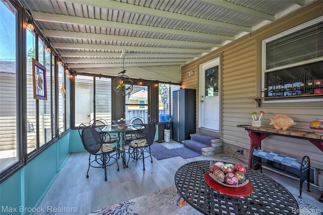 2233 Kohler St, Waterford, MI 48329 - sunroom with entry steps, beamed ceiling, and outdoor dining area