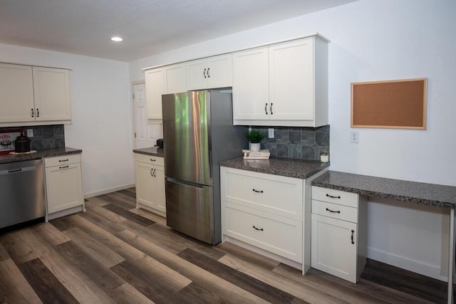 1120 8th St, Three Rivers, MI 49093 - kitchen with appliances with stainless steel finishes, tasteful backsplash, recessed lighting, white cabinets, and dark wood finished floors