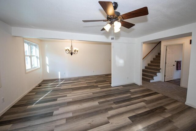 1120 8th St, Three Rivers, MI 49093 - unfurnished room with stairway, wood finished floors, a chandelier, and a ceiling fan