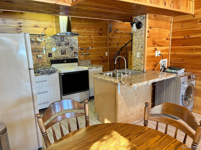 221 Bluegill Lake Dr, Frost, MI 48625 - kitchen with electric range oven, freestanding refrigerator, island range hood, wood walls, and washer / clothes dryer