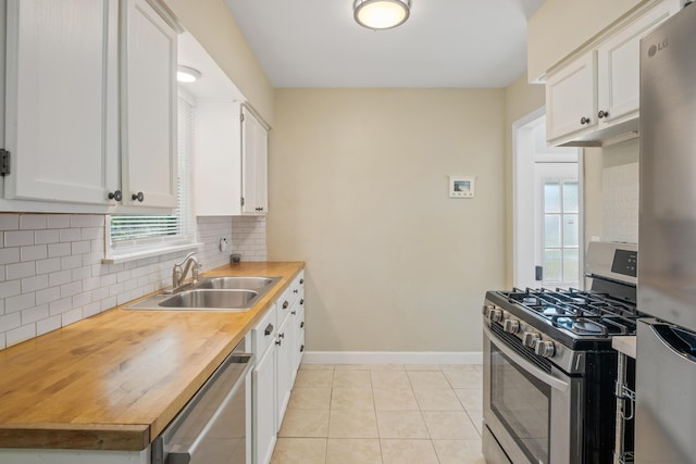 3061 Homewood St SW, Grandville, MI 49418 - kitchen with appliances with stainless steel finishes, healthy amount of natural light, tasteful backsplash, and white cabinets