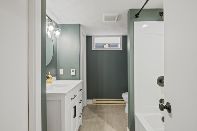 3061 Homewood St SW, Grandville, MI 49418 - bathroom featuring a baseboard heating unit, vanity, and  shower combination
