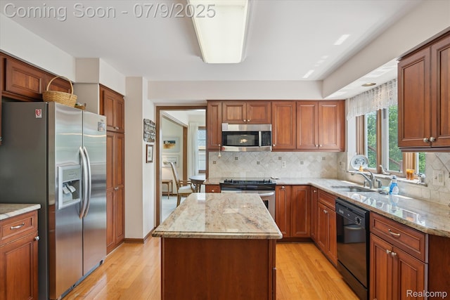 48721 W Normandy Ct, Plymouth, MI 48170 - kitchen featuring appliances with stainless steel finishes, light wood-style flooring, a kitchen island, and light stone counters
