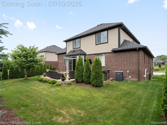 62777 Franklin Park Dr, Washington, MI 48094 - back of property featuring brick siding, a patio, a yard, and a shingled roof