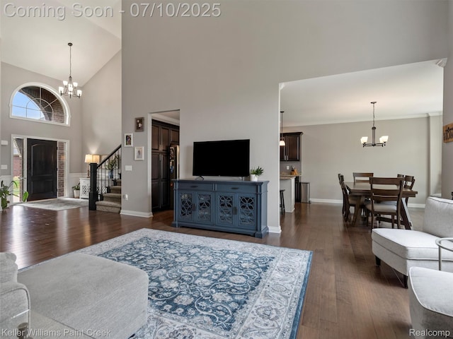 62777 Franklin Park Dr, Washington, MI 48094 - living room featuring a chandelier, stairway, a high ceiling, and dark wood-style floors