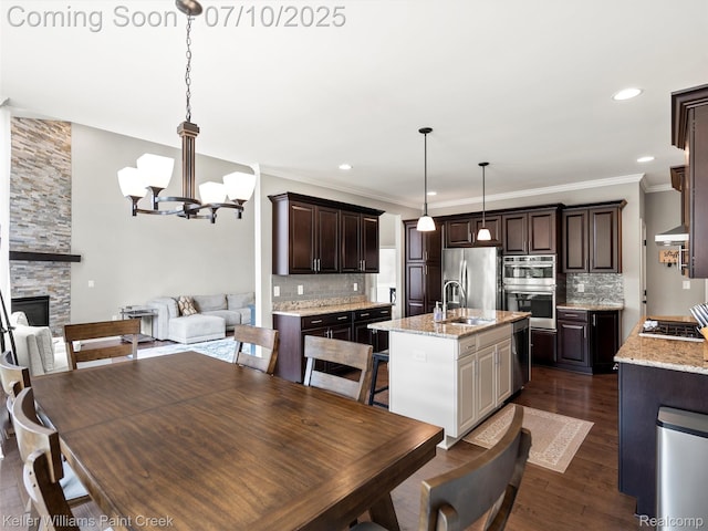 62777 Franklin Park Dr, Washington, MI 48094 - dining room featuring a chandelier, a fireplace, dark wood-style flooring, crown molding, and recessed lighting