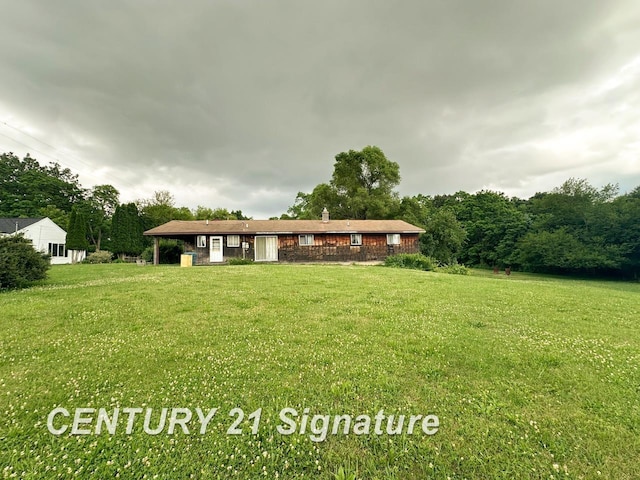 2410 Jossman Rd, Holly, MI 48442 - view of front facade featuring a front yard and a chimney