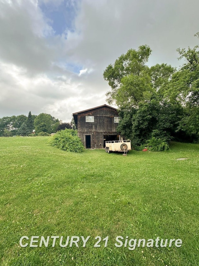 2410 Jossman Rd, Holly, MI 48442 - view of green lawn with a barn and an outdoor structure