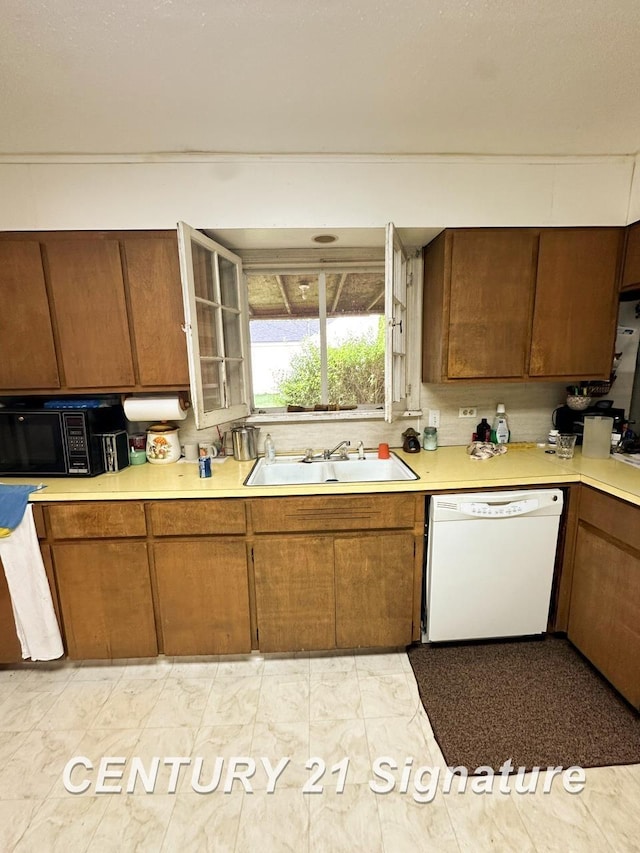 2410 Jossman Rd, Holly, MI 48442 - kitchen with dishwasher, black microwave, light countertops, and brown cabinetry