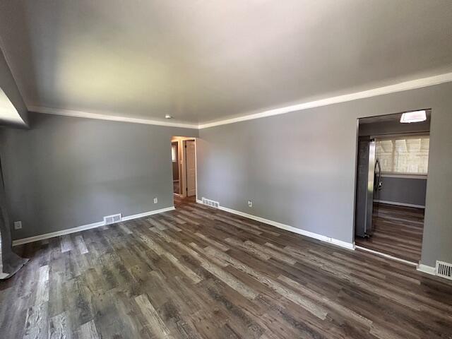 26219 Clarita St, Redford, MI 48240 - unfurnished living room with dark wood-type flooring and ornamental molding