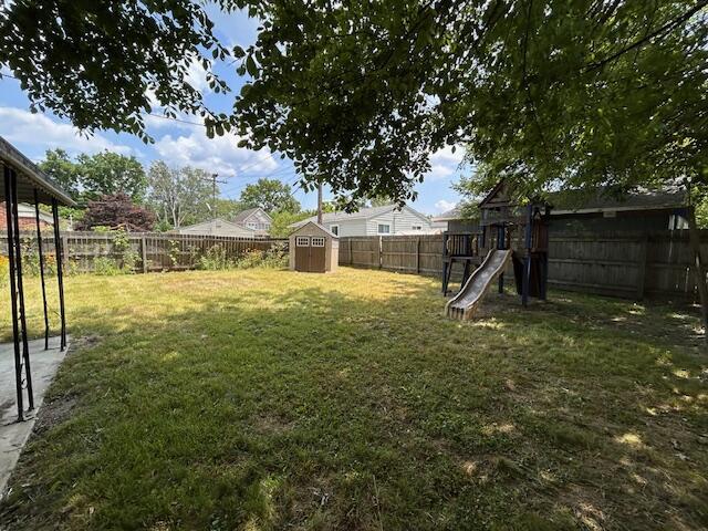 26219 Clarita St, Redford, MI 48240 - fenced backyard with a storage unit and a playground