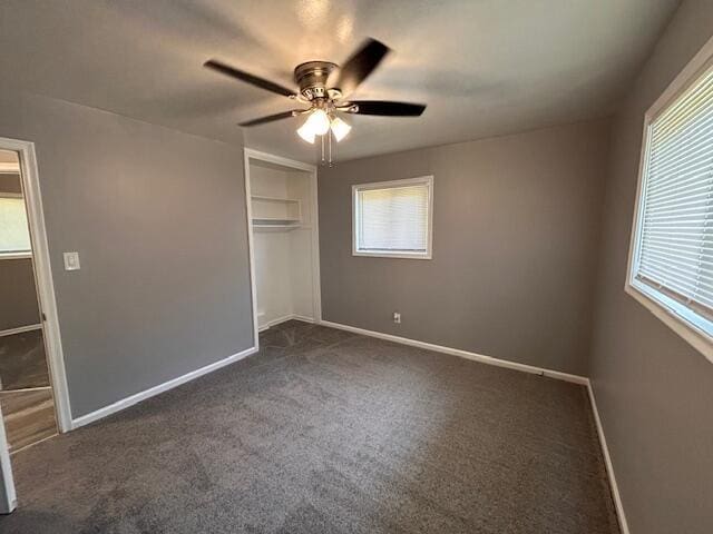 26219 Clarita St, Redford, MI 48240 - unfurnished bedroom featuring multiple windows and dark colored carpet