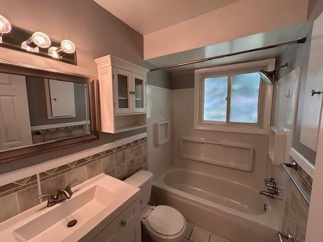 26219 Clarita St, Redford, MI 48240 - full bathroom with bathing tub / shower combination, vanity, decorative backsplash, and tile patterned floors