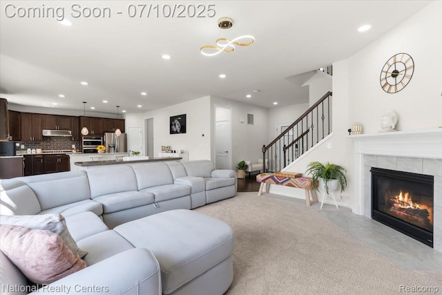 28049 Hummingdale Cir, Novi, MI 48377 - living room with recessed lighting, stairway, a tiled fireplace, and light tile patterned floors