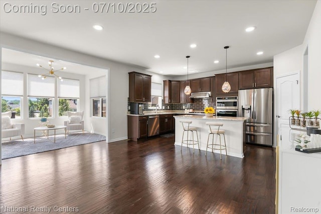 28049 Hummingdale Cir, Novi, MI 48377 - kitchen featuring stainless steel appliances, under cabinet range hood, light countertops, dark brown cabinets, and recessed lighting