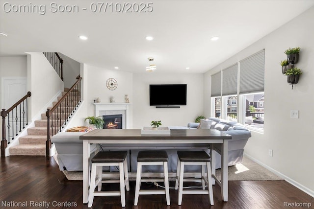 28049 Hummingdale Cir, Novi, MI 48377 - living room with a tiled fireplace, recessed lighting, stairway, and dark wood-style flooring