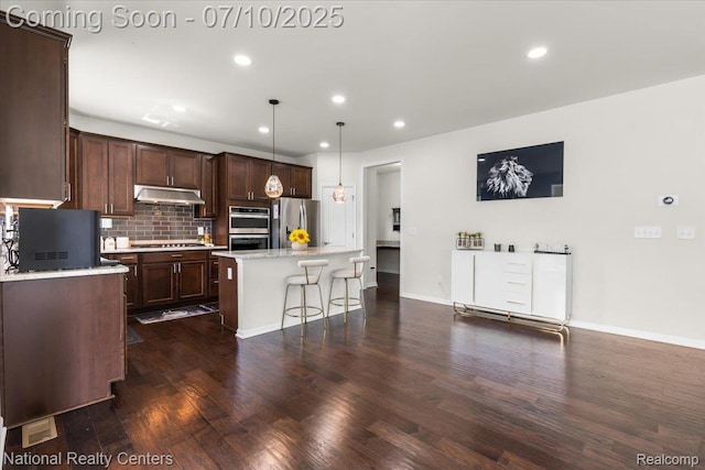 28049 Hummingdale Cir, Novi, MI 48377 - kitchen featuring under cabinet range hood, stainless steel appliances, dark wood-style flooring, recessed lighting, and a center island