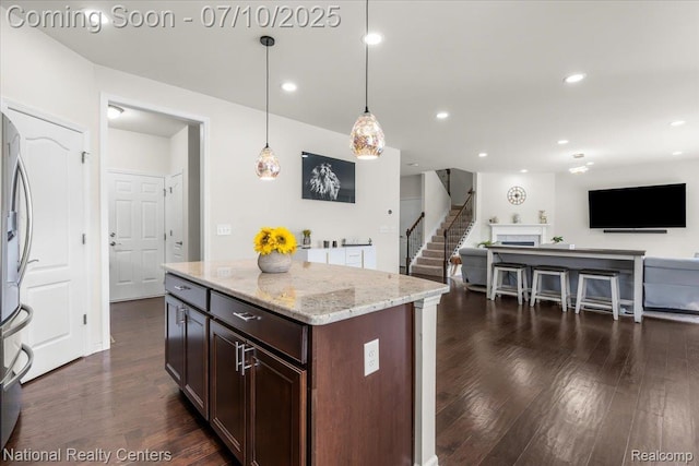 28049 Hummingdale Cir, Novi, MI 48377 - kitchen with dark wood finished floors, open floor plan, light stone countertops, and recessed lighting