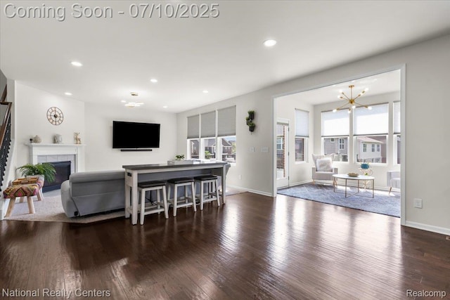 28049 Hummingdale Cir, Novi, MI 48377 - living area with wood finished floors, a fireplace, recessed lighting, and a chandelier