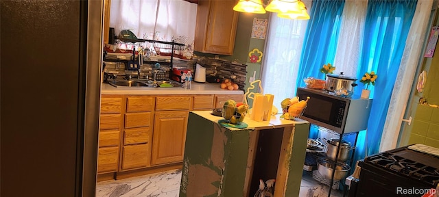 5035 Balfour Rd, Detroit, MI 48224 - kitchen featuring appliances with stainless steel finishes, light countertops, and a chandelier