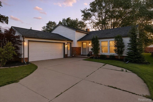 42109 Hartford Dr, Canton, MI 48187 - view of front facade with concrete driveway, a garage, a front yard, and brick siding