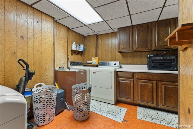 42109 Hartford Dr, Canton, MI 48187 - laundry area featuring cabinet space, light floors, washer and dryer, and wood walls
