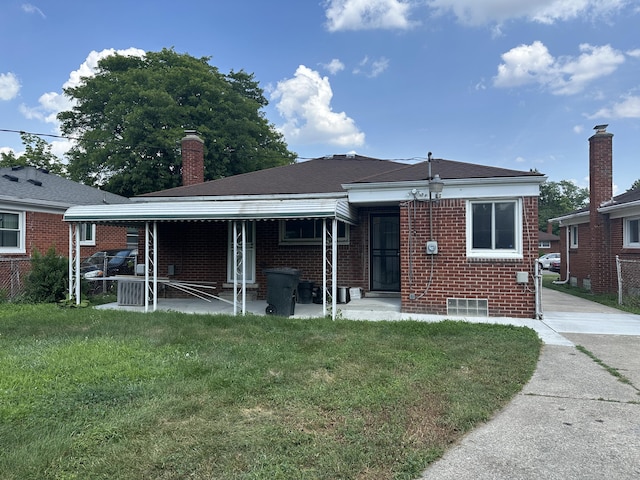 20523 Burt Rd, Detroit, MI 48219 - back of property featuring brick siding, a chimney, and a patio area