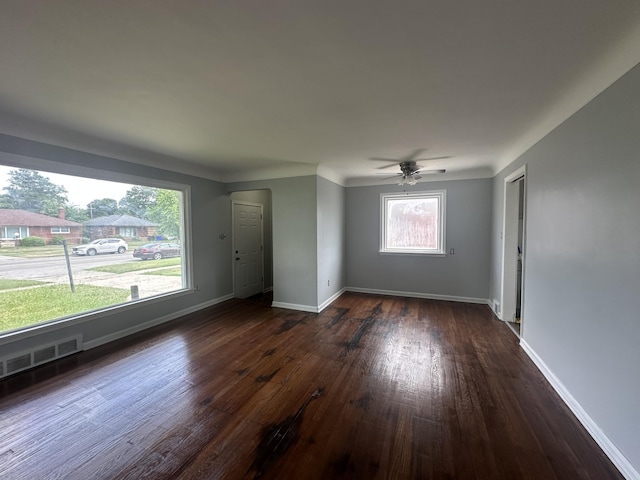 20523 Burt Rd, Detroit, MI 48219 - unfurnished living room with dark wood-type flooring, ceiling fan, and arched walkways