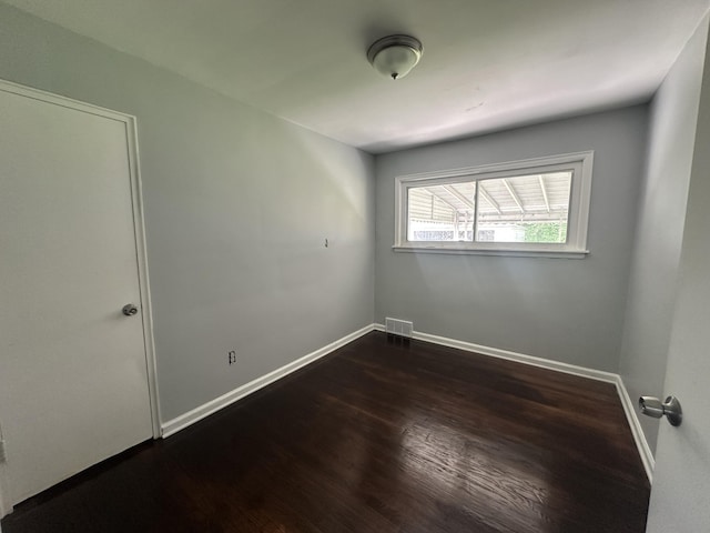 20523 Burt Rd, Detroit, MI 48219 - empty room featuring dark wood-style floors and baseboards
