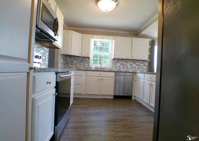 3380 Stewart Rd, Monroe, MI 48162 - kitchen with stainless steel appliances, ornamental molding, white cabinetry, and backsplash