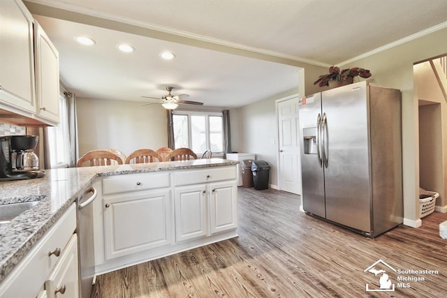 3380 Stewart Rd, Monroe, MI 48162 - kitchen featuring appliances with stainless steel finishes, a kitchen breakfast bar, a ceiling fan, white cabinets, and recessed lighting