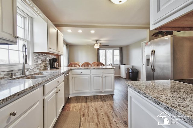 3380 Stewart Rd, Monroe, MI 48162 - kitchen with a peninsula, recessed lighting, a ceiling fan, appliances with stainless steel finishes, and light wood finished floors