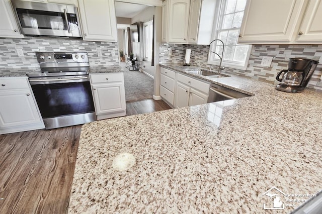 3380 Stewart Rd, Monroe, MI 48162 - kitchen featuring stainless steel appliances, dark wood-type flooring, light stone countertops, and backsplash