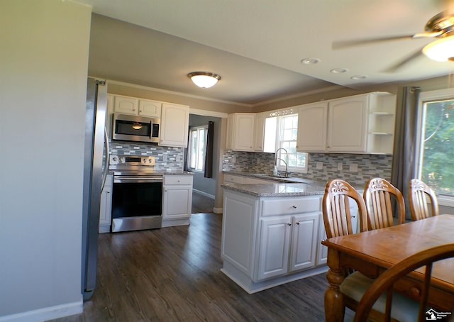 3380 Stewart Rd, Monroe, MI 48162 - kitchen featuring stainless steel appliances, white cabinetry, tasteful backsplash, and ornamental molding