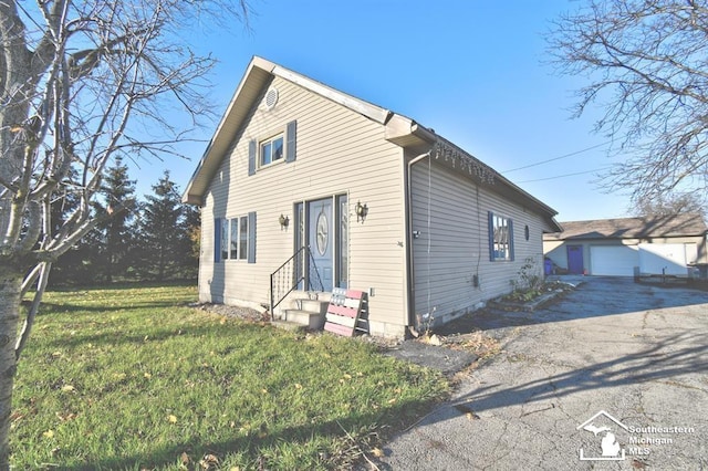 3380 Stewart Rd, Monroe, MI 48162 - view of front of house featuring entry steps, an outbuilding, a garage, a front lawn, and driveway
