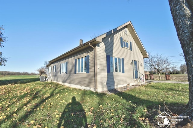 3380 Stewart Rd, Monroe, MI 48162 - view of property exterior with a central AC unit and a yard