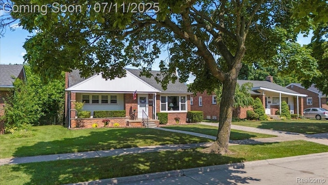 1946 Carlysle St, Dearborn, MI 48124 - view of front facade with brick siding and a front yard