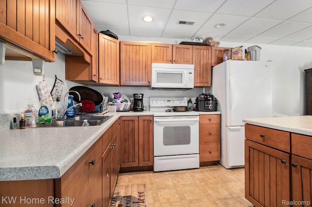 4450 Sylvan Rd, Grass Lake, MI 49240 - kitchen with white appliances, light countertops, a paneled ceiling, brown cabinets, and recessed lighting