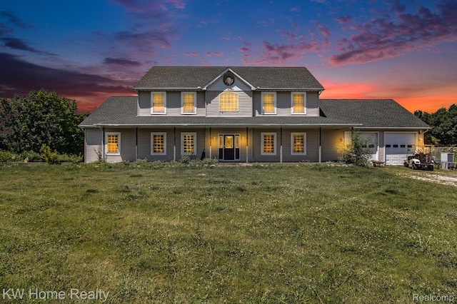 4450 Sylvan Rd, Grass Lake, MI 49240 - view of front of home with an attached garage, a porch, and a lawn