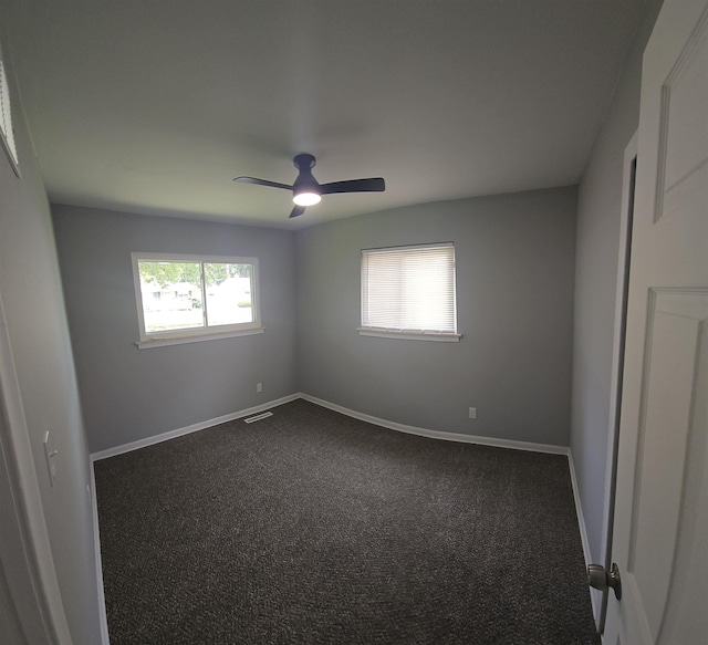 3736 Maryland Ave, Flint, MI 48506 - spare room with dark colored carpet and a ceiling fan