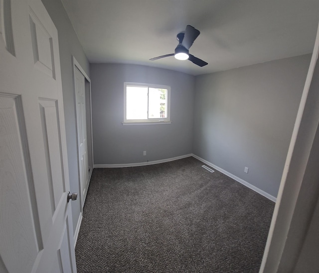 3736 Maryland Ave, Flint, MI 48506 - unfurnished bedroom featuring dark carpet and a ceiling fan