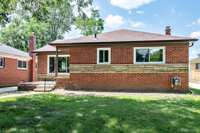 23461 Avon Rd, Oak Park, MI 48237 - back of property with a chimney, a lawn, brick siding, and roof with shingles